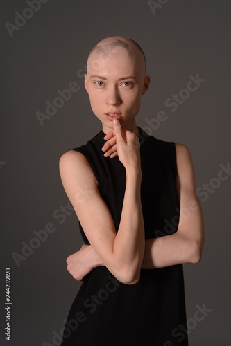 bald girl posing in Studio in black dress © korotkovkris