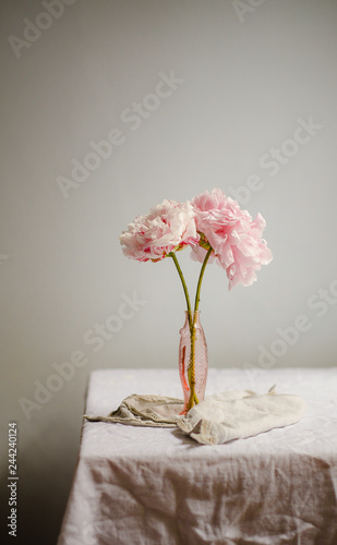 Принти на полотні Pink peonies in a vase on a linen tablecloth