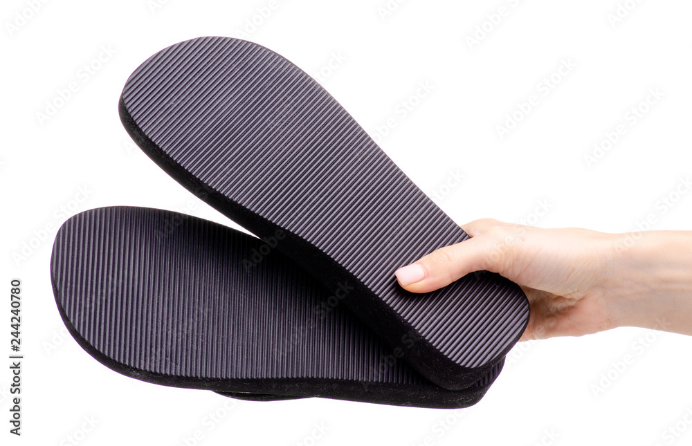 Black flip flops rubber in hand on white background isolation