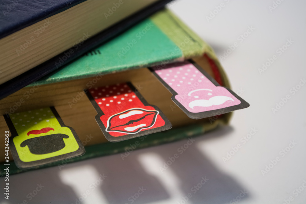 Old books on a white background. Cheerful and amusing bookmarks with moustaches of different coloring. Home library.