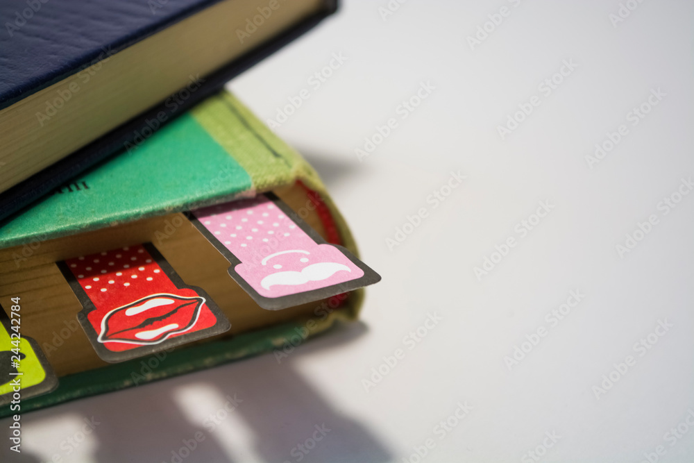 Old books on a white background. Cheerful and amusing bookmarks with moustaches of different coloring. Home library. Old books on a white background. Cheerful and amusing bookmarks with moustaches of different coloring. Home library.