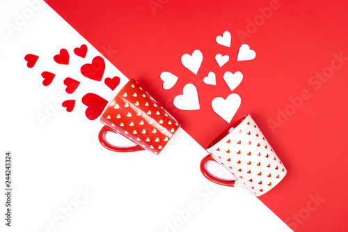 Mugs with scattered hearts on red and white.