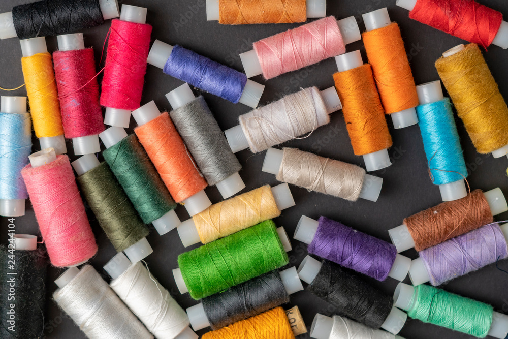 bunch of colorful sew threads lay on dark background isolated d bunch of colorful sew threads lay on dark background isolated d