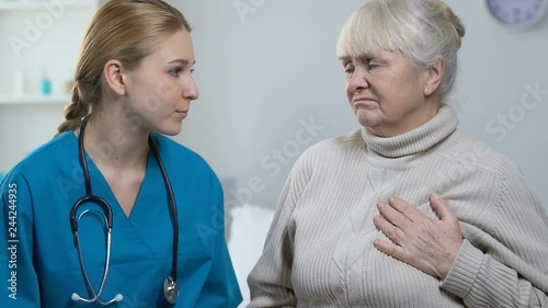 Wallpaper Mural Aged woman patient telling doctor about strong pain in chest, calling paramedics Torontodigital.ca