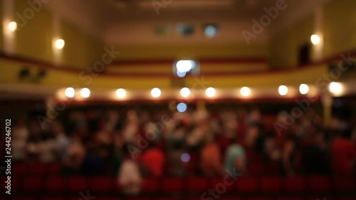 An interlude in the theater. Theatrical work is finished. The people in the theater leave the hall.