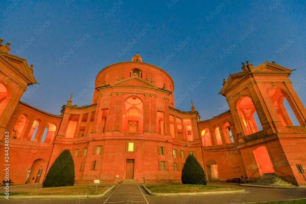 Sanctuary of Madonna di San Luca basilica church illuminated at blue hour. Central facade of Cathedral of San Luca on the hills of Bologna, Emilia-Romagna, Italy. Famous landmark cityscape. Copy space