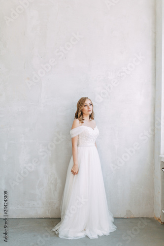  Fees in the interior Studio in the European style. The bride in a white wedding dress. © pavelvozmischev
