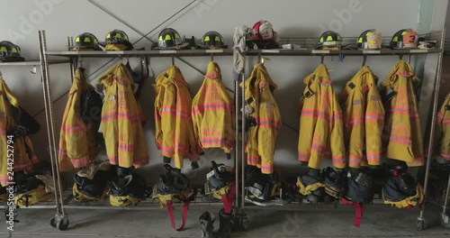 Firefighter gear hanging in fire station photo