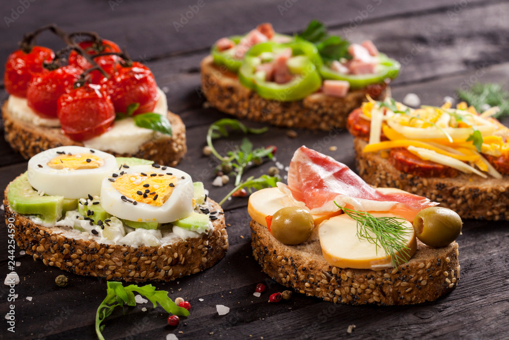 Set of different bruschettas on dark wooden table. Set of different bruschettas on dark wooden table.