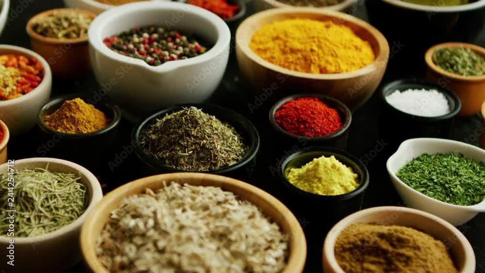 From above view of many little bowls with different kinds of spices laid on wooden background From above view of many little bowls with different kinds of spices laid on wooden background