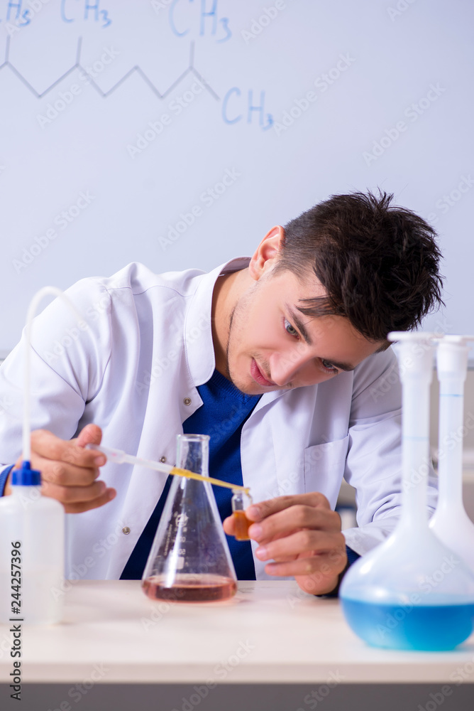 Young chemist sitting in the lab Young chemist sitting in the lab