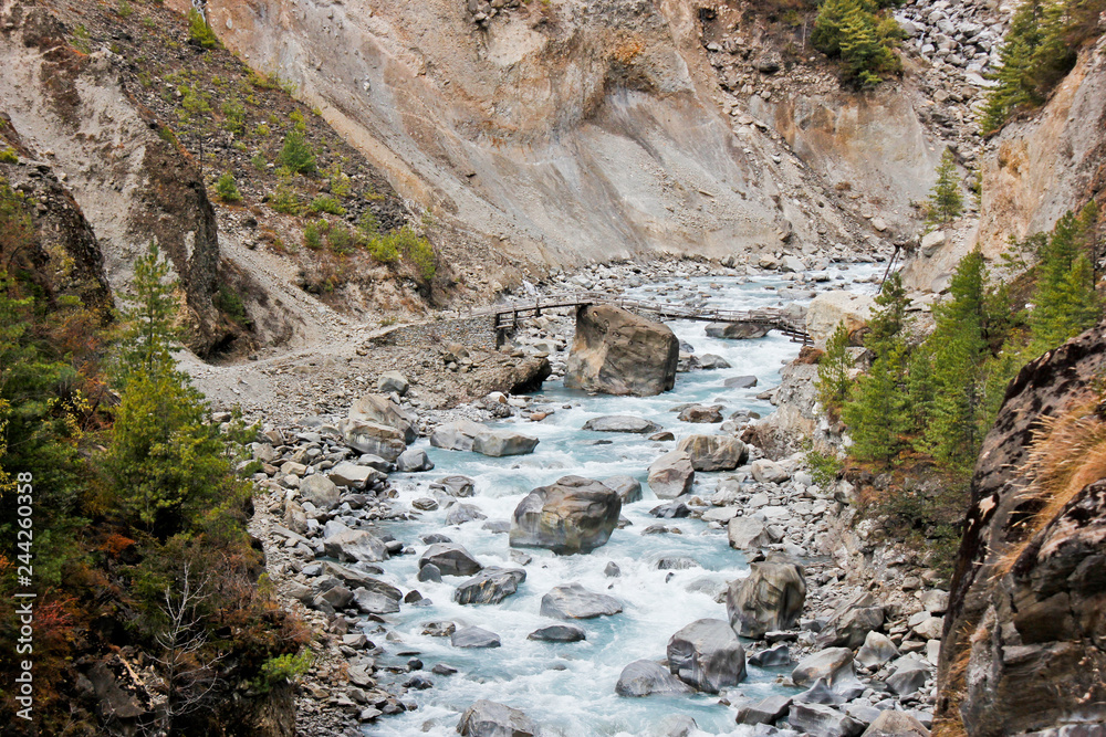 Obraz premium Wooden bridge over a small stream in Nepal