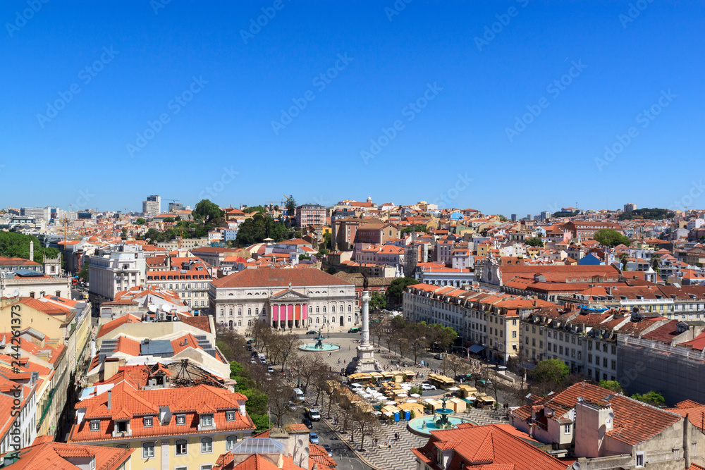 The view of the city from from Santa Justa Lift  on a sunny summer day. The roofs of the houses and Rossio Square.
