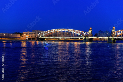 Peter the Great Bridge over the Neva river embankment. White nights in St. Petersburg, Russia. Bolsheokhtensky Bridge. © Vera