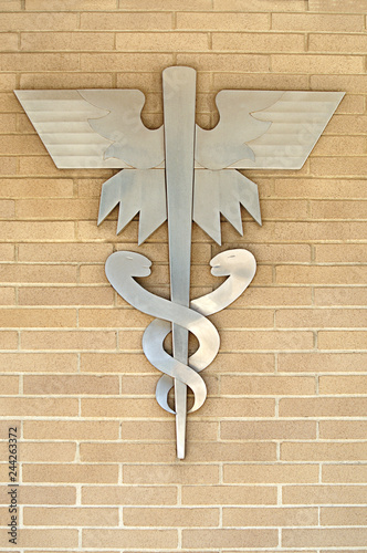 Medical Symbol or Emblem onLight Tan Brick Wall