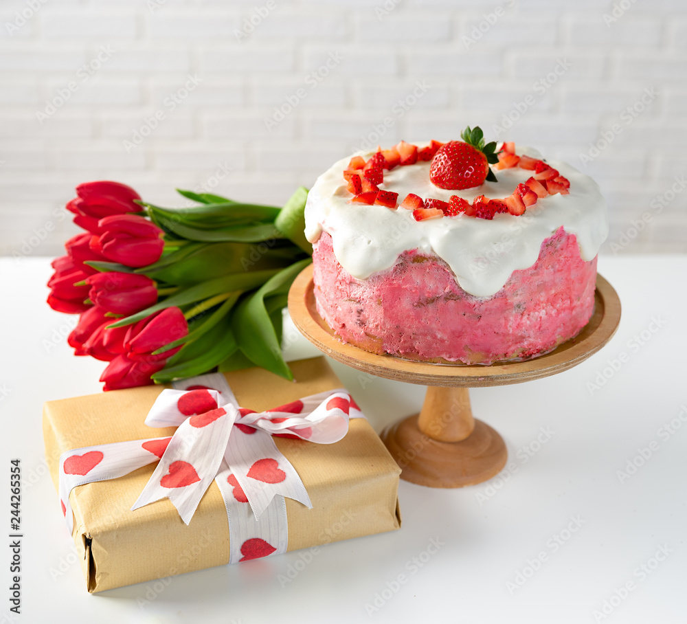 Strawberry cake with gift box and bunch of tulips Strawberry cake with gift box and bunch of tulips