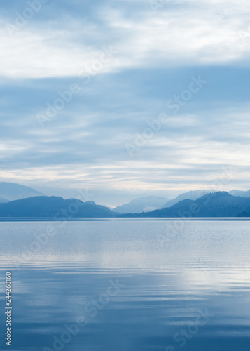 Silhoutte of mountains with sky reflected on calm lake