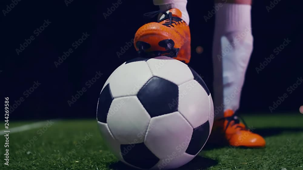 Professional soccer player putting his boot on the ball, 4k slow motion