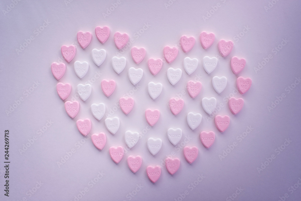 Valentine pastel pink and white heart candies shaped in a big heart