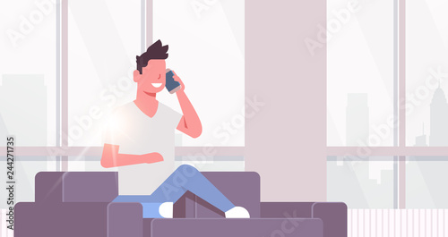 young man phone calling happy guy sitting couch using smartphone communication concept modern living room interior cityscape background flat horizontal
