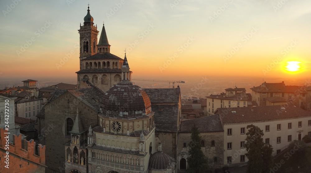 Bergamo, Italy. The old town. Aerial view of the Basilica of Santa Maria Maggiore during the sunset. In the background the Po plain