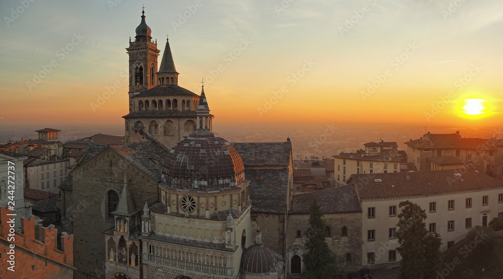 Bergamo, Italy. The old town. Aerial view of the Basilica of Santa Maria Maggiore during the sunset. In the background the Po plain