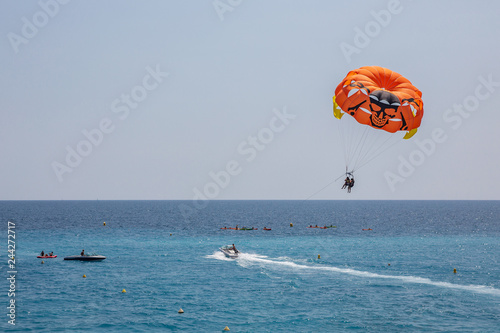 Speedboat and parasailer at Nice beach in the south of France photo