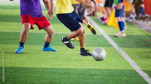 soccer players run to trap and control the ball for shoot to goal with cheerleader team background.