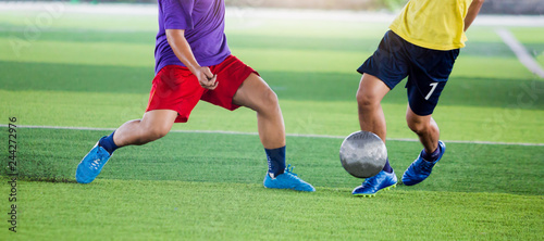 soccer players run to trap and control the ball for shoot to goal.
