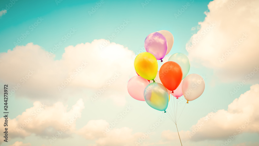 Vintage multicolor balloons with done with a retro instagram filter effect on blue sky. Ideas for the background of love in summer and valentine, wedding honeymoon concept.