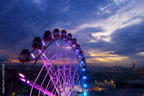 Beautiful scenery of ferris wheel with twilight sky