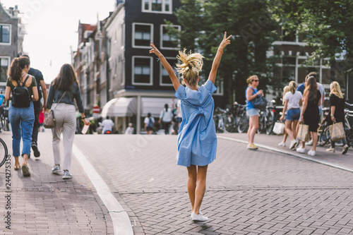 happy girl in blue dress in amsterdam.