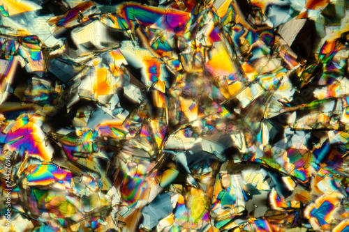 Abstract micrograph of colorful crystals of the amino acid phenylalanine.