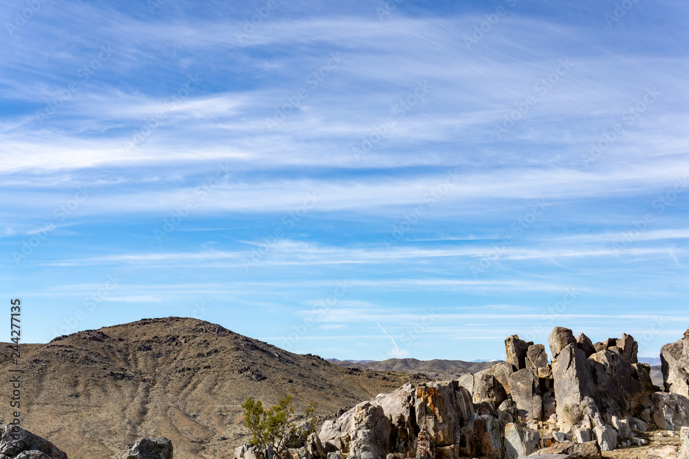Blue sky landscape with a rocky foreground