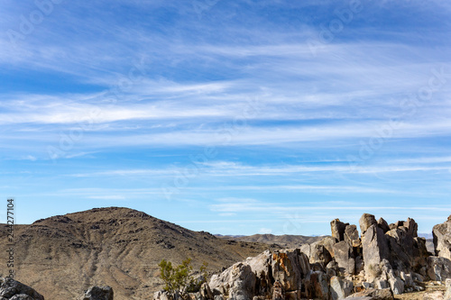 Blue sky landscape with a rocky foreground