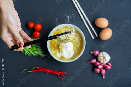 Unknown woman hands holding boiled noodle