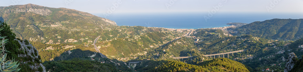 Panoramic view of Menton and the surrounding hillside buildings in front of the A8 bridge road, as captured from Sainte Agnes