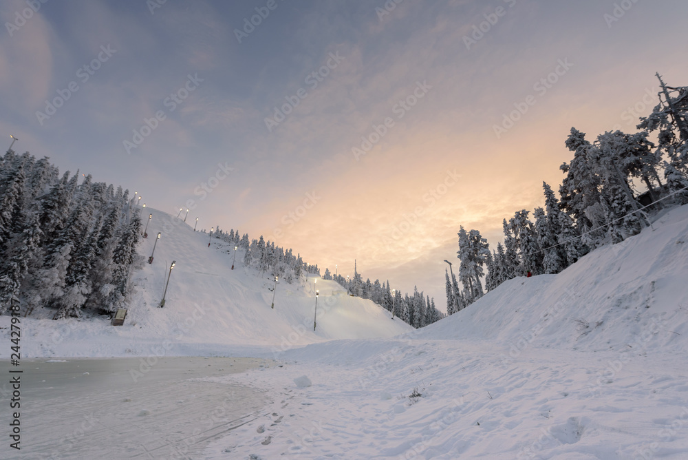 Rukatunturi ski jumping hill in winter season and nice weather and blue sky in winter season and sunset time at Ruka ski Rukatunturi, Finland