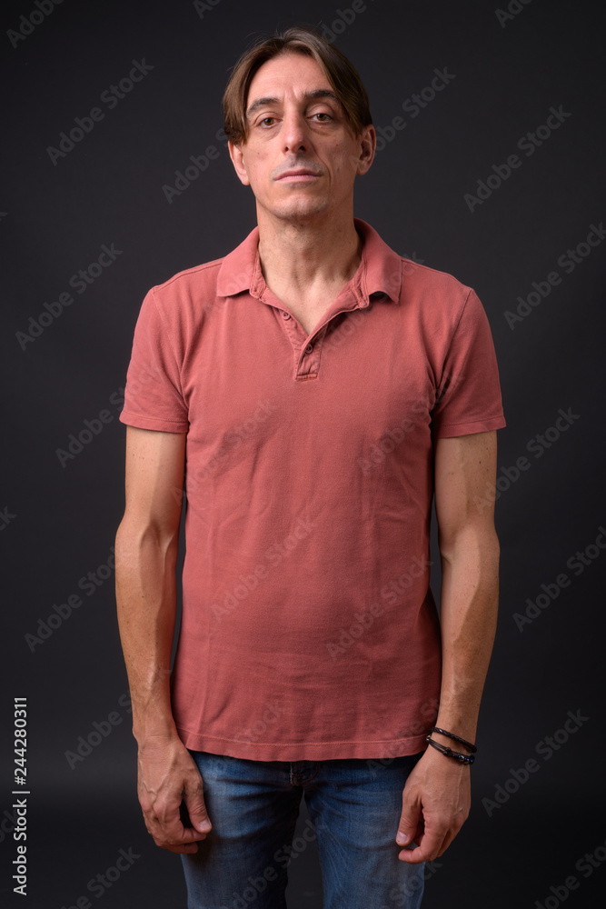 Mature handsome Italian man against gray background Mature handsome Italian man against gray background
