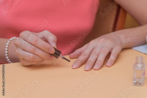 girl paints nails, nail care, manicure at home