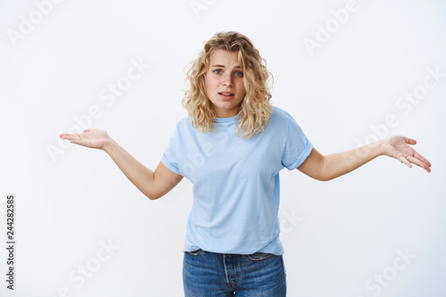 Come on show me what you got. Portrait of arrogant and snobbish girl pissing off person challenging not giving fuck on people shrugging and spread hands sideways unbothered about others opinion