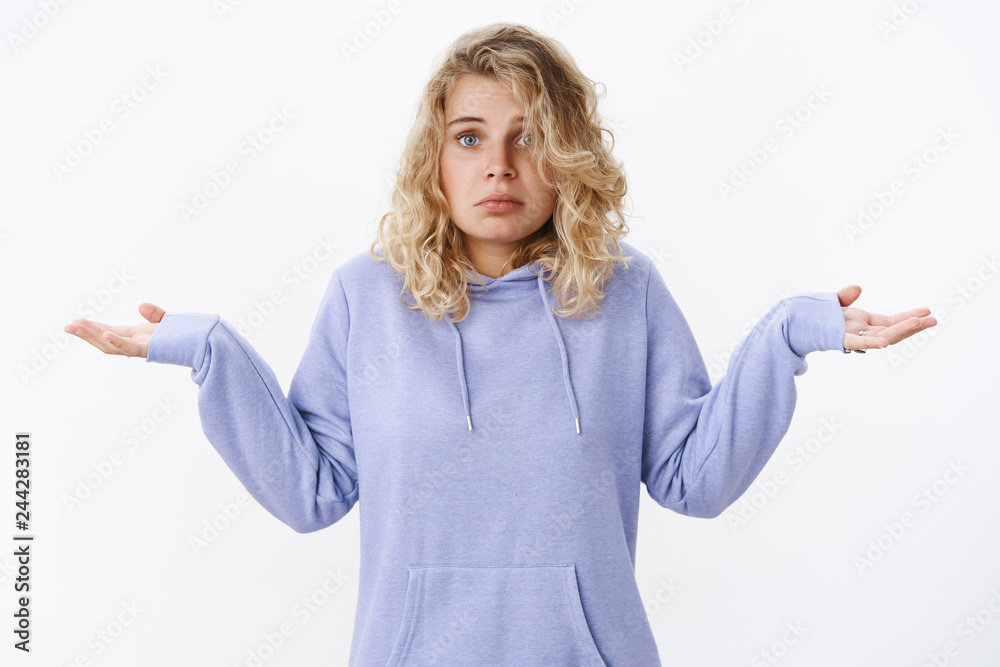I not know how happened. Portrait of confused and upset clumsy cute and silly girl with short curly haircut shrugging and spread hands sideways in hopeless unaware gesture over white background I not know how happened. Portrait of confused and upset clumsy cute and silly girl with short curly haircut shrugging and spread hands sideways in hopeless unaware gesture over white background