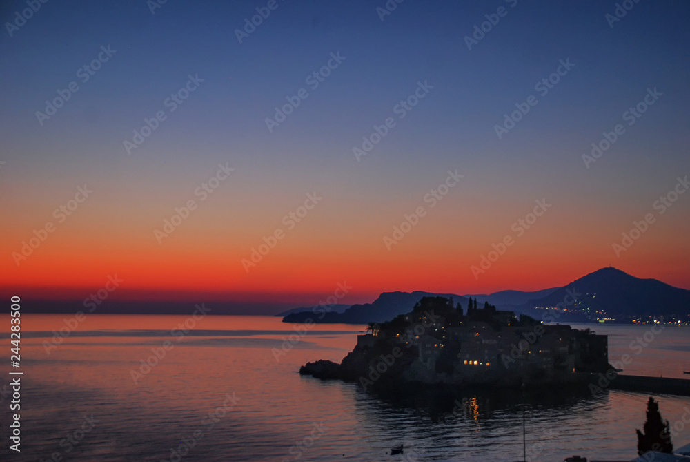 Sunset over the luxury resort of Sveti Stefan on the coast of Montenegro Sunset over the luxury resort of Sveti Stefan on the coast of Montenegro