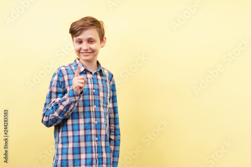 idea, enlightening, insight, comprehension. happy and confident grinning boy gesturing over yellow background, advertisement, banner or poster template, emotion, people reaction