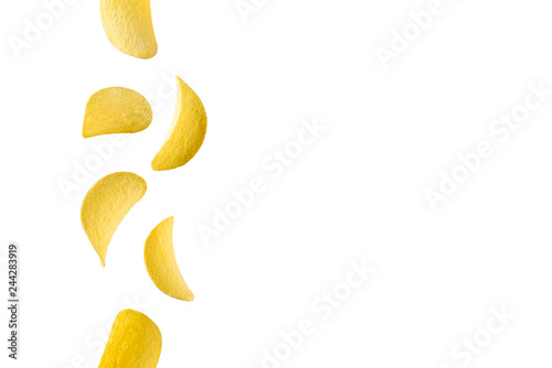 Falling potato chips isolated on white background. Flying crispy snacks
