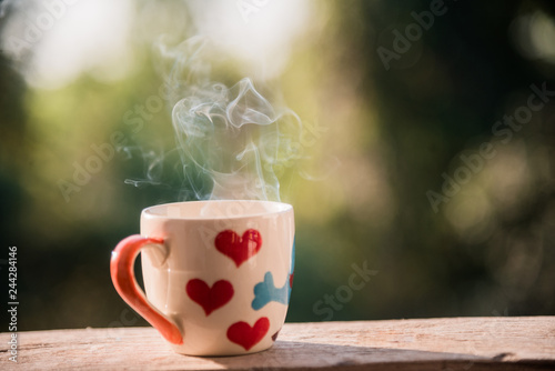 coffee cup with smoke on blur background.