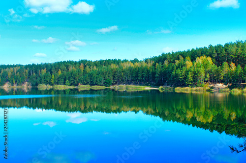 Forest lake with emerald water. Beautiful lake panorama
