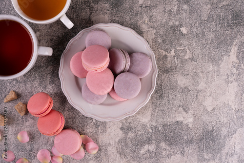 Wedding, St. Valentine's Day, birthday, preparation, holiday. Beautiful pink tasty macaroons on a concrete background