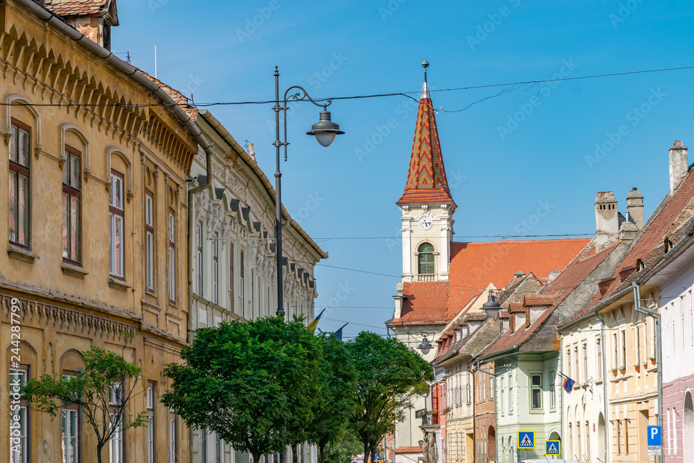 Obraz premium Sibiu, Romania - Beautiful street with Reformed Church on a sunny summer day in Sibiu, Romania