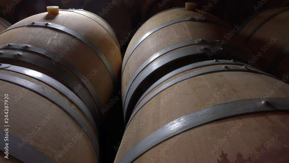 Oak barrels of wine in the cellar, Bordeaux Vineyard, France Oak barrels of wine in the cellar, Bordeaux Vineyard, France